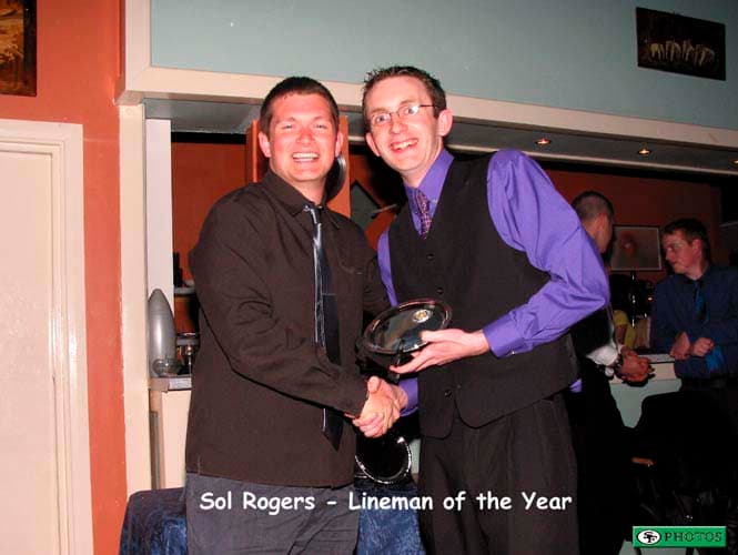 Sol Rogers collects his Lineman of the Year award from D-Line coach Anthony Fitzpatrick.