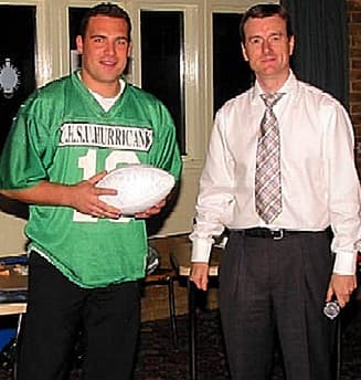 Matt Coppinger, in his retired #19 shirt, receives a game ball from Head Coach Jim Messenger at the Rookies and Legends Evening 2002.