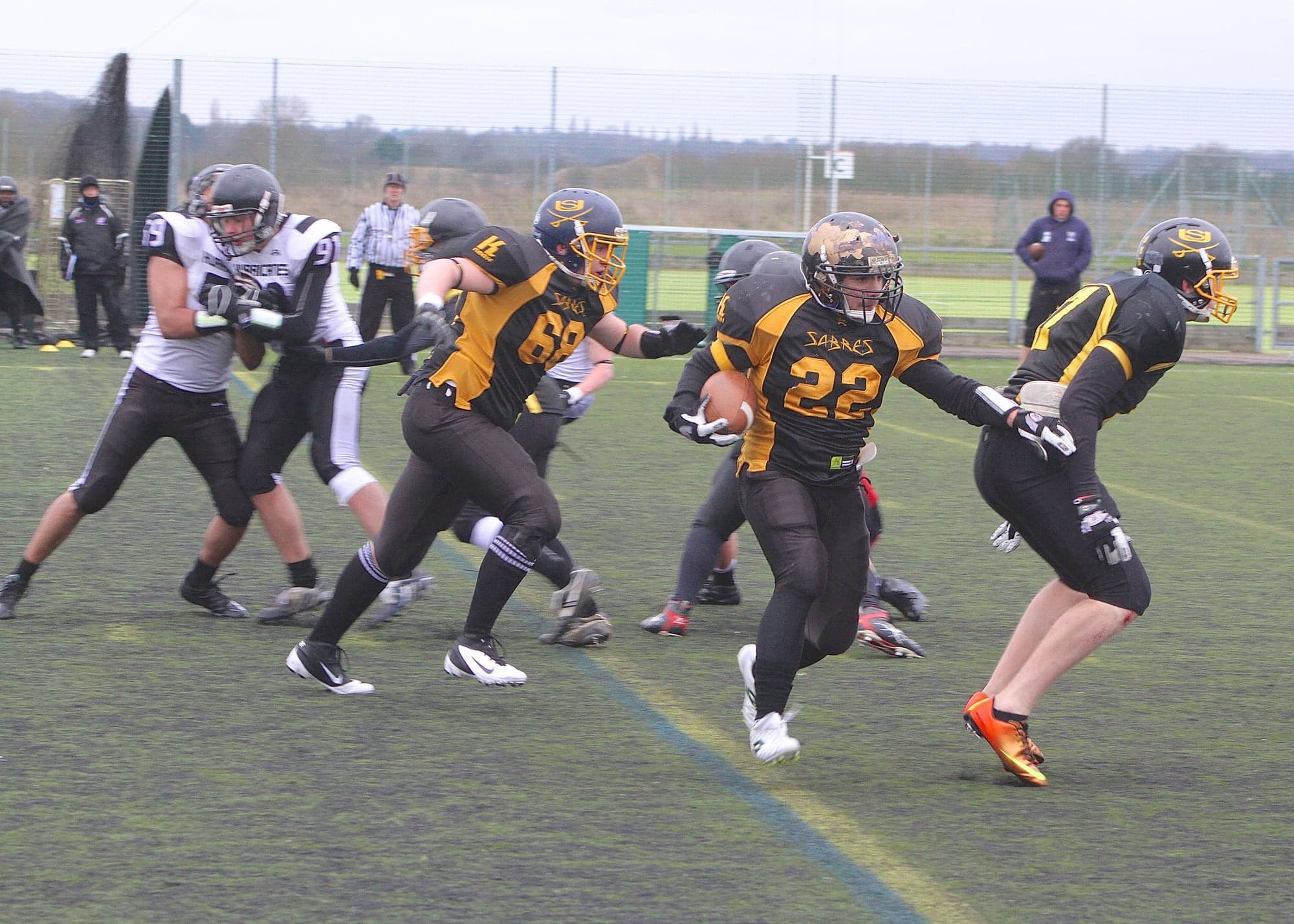 Cover me - Nico Bianco (#22) emerges from behind the wall of steel to give the Sheffield Sabres a first down.